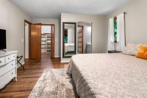 a bedroom with a bed and a tv and mirror at Lakeside Getaway includes Hot Tub pet friendly in Gaylord