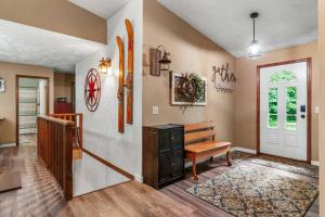 a living room with a bench and a door at Lakeside Getaway includes Hot Tub pet friendly in Gaylord +25 photos