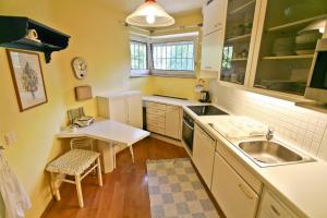 a small kitchen with a sink and a table at Exclusive House in Salzburg City in Salzburg