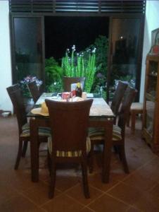 a dining room table and chairs with a fish tank at hostal posada san jose in Suaita +4 photos