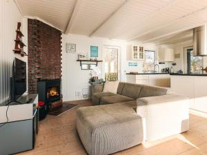 a living room with a couch and a fireplace at Secluded Beach Retreat - By Traum Ferienwohnungen in Lihme