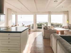 a kitchen and living room with a view of the ocean at Secluded Beach Retreat - By Traum Ferienwohnungen in Lihme