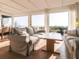 a living room with couches and a coffee table at Secluded Beach Retreat - By Traum Ferienwohnungen in Lihme