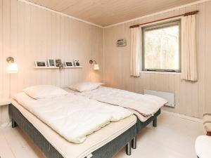 a large bed in a room with a window at Secluded Beach Retreat - By Traum Ferienwohnungen in Lihme