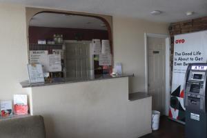 a room with a counter and a mirror in a store at Sands Hotel Formerly OYO Hotel in Blytheville