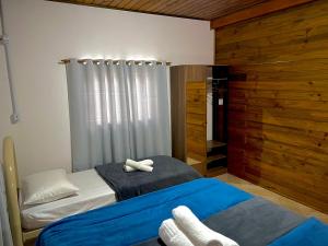 a bedroom with two beds and a window at Casa Jardinada in Pomerode