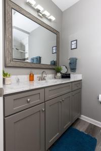 a bathroom with a sink and a mirror at Little Rock - Stylish Little Rock Downtown Escape in Little Rock