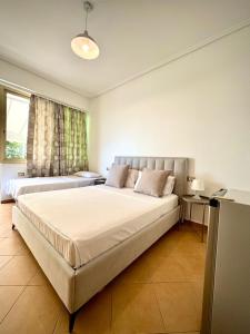 a bedroom with two beds and a window at Vila Rahmi & Veli Dervishaj in Vlorë