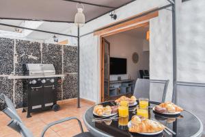 a table with plates of food on top of it at Paradise Dúplex Garden & Beach Maspalomas in San Bartolomé