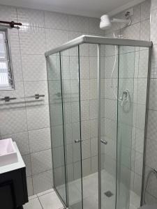 a shower with a glass door in a bathroom at A melhor vista de São Vicente in São Vicente