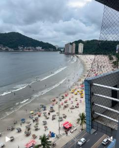 a beach with many umbrellas and people on it at A melhor vista de São Vicente in São Vicente
