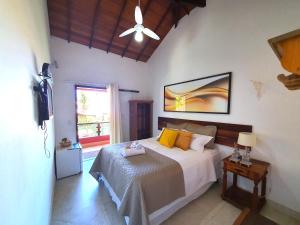 a bedroom with a large bed and a window at Star Búzios Pousada in Búzios +172 photos