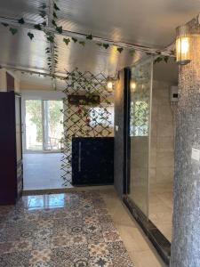 a lobby with a glass door and a tile floor at ZBB Villa & Bungalow in Alanya