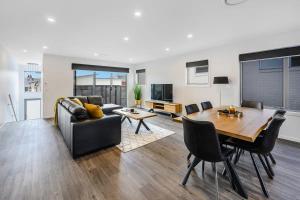 a living room with a table and a couch at Villa 4 NEW 3Bed 2 Bath in Warrane +35 photos