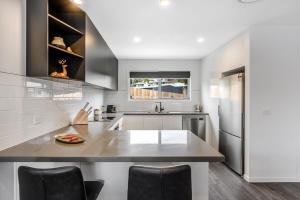 a kitchen with a counter top and a refrigerator at Villa 4 NEW 3Bed 2 Bath in Warrane