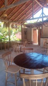 a patio with a table and chairs under a roof at El Farol Bistrô e Pousada in Fortim
