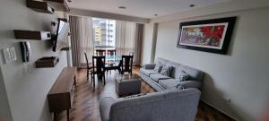 a living room with a couch and a table at RESIDENCIAL QUIÑONES in Cusco