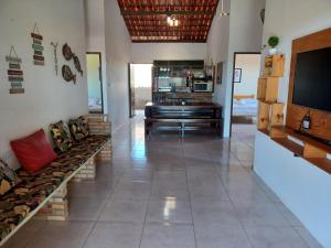 a living room with a television and a couch at Casa Florida in Beberibe