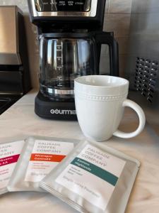 a coffee maker and a cup on a counter at Posh Cottage Wine Country Mountain View Retreat in Palisade