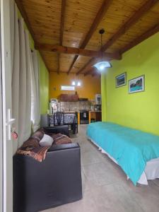 a living room with a couch and a kitchen at Lo de Kami in Ushuaia +18 photos