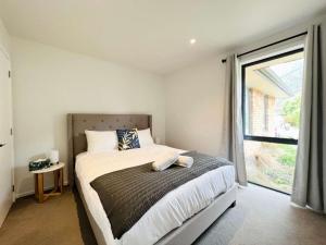 Katil atau katil-katil dalam bilik di Cosy 4 Bedroom Home