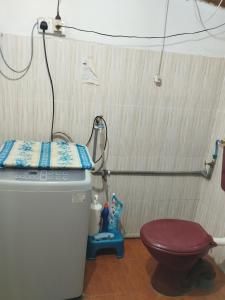 a small bathroom with a toilet and a shower at Inap Desa Jalan Baru in Kampong Sedim Number Two +5 photos