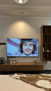 a large flat screen tv on a wall in a bedroom at Nest نيست in Riyadh