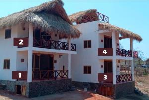 ein Haus mit Hausnummern an der Seite in der Unterkunft Cabañas Mizontle in Mazunte