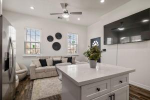 a kitchen and living room with a couch and a table at Modern and Serene Oasis Mins from Downtown Houston in Houston