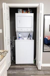 a door leading into a kitchen with a microwave at Little Rock - Cozy Downtown Retreat in Little Rock