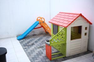 a toy play house and a slide in a room at House in Miraflores Cuenca in Cuenca