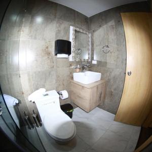 a bathroom with a toilet and a sink at House in Miraflores Cuenca in Cuenca +29 photos