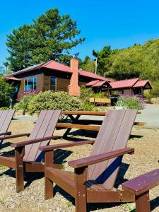 a group of picnic tables in front of a building at Limantour Lodge in Point Reyes Station