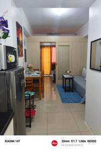 a kitchen and living room with a couch and a table at Condo unit in Manila