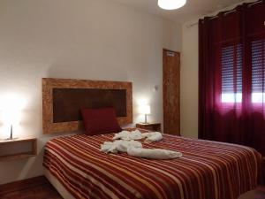 a bedroom with a bed with a stuffed animal on it at Huge 3 Bedrooms Balcony Flat for 8 pax in Seia