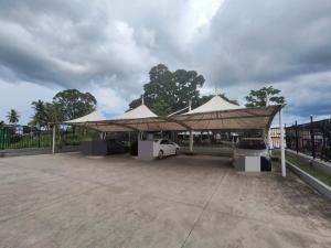 a group of tents with a car parked under it at Alice Luxury Apartments near Nadi McDonald's in Nadi