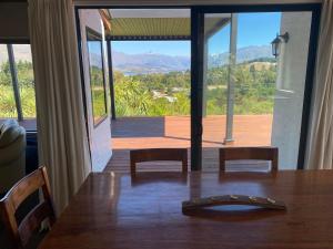 a dining room table with a view of the mountains at Ridgehouse Wanaka in Wanaka +7 photos