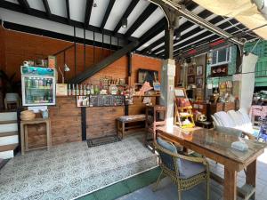 a store with a table and chairs in a room at Green Teak House in Bangkok