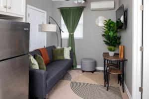 a living room with a couch and a table at Little Rock Hideaway Cozy, Chic & Convenient in Little Rock