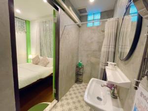 a bathroom with a sink and a bedroom with a bed at Green Teak House in Bangkok +94 photos