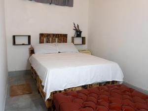 a bedroom with a large bed and a red couch at La Vieja Habana Zona Colonial in Santo Domingo +11 photos