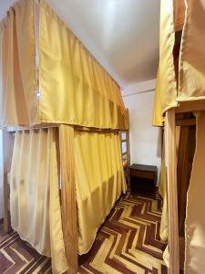 a room with two bunk beds with yellow curtains at jtjy in San Antonio