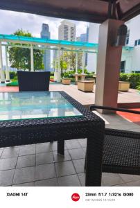 a glass table sitting on top of a patio at Condo unit open for staycation in Manila