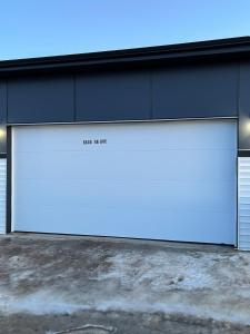a garage door with the words back at night on it at Elegant 3BD Home in Beaumont, Double Garage in Nisku