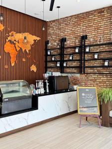 a restaurant with a map of the world on the wall at Celine Express - Q Dalat Hotel in Da Lat