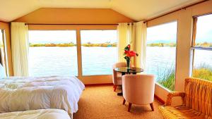 a bedroom with a bed and a view of the water at Titicaca Floating Lodge in Puno