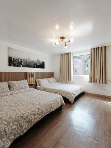 a bedroom with two beds and a window at HeiStay-30sec from Hongdae SubwayStop-Elevator in Seoul