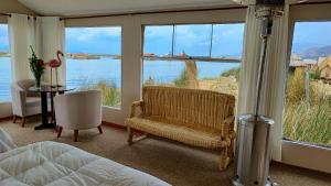 a bedroom with a bed and a view of the water at Titicaca Floating Lodge in Puno