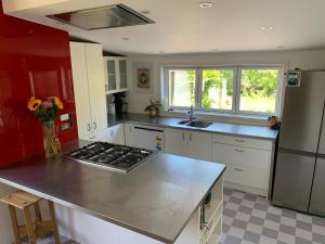 a kitchen with a counter and a stove top oven at Riverside City Villa with Hot tub in Nelson