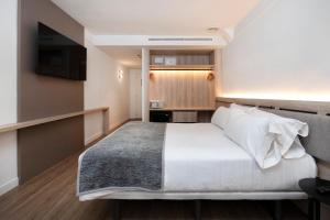 Una cama o camas en una habitación de Sercotel Delfos Andorra
